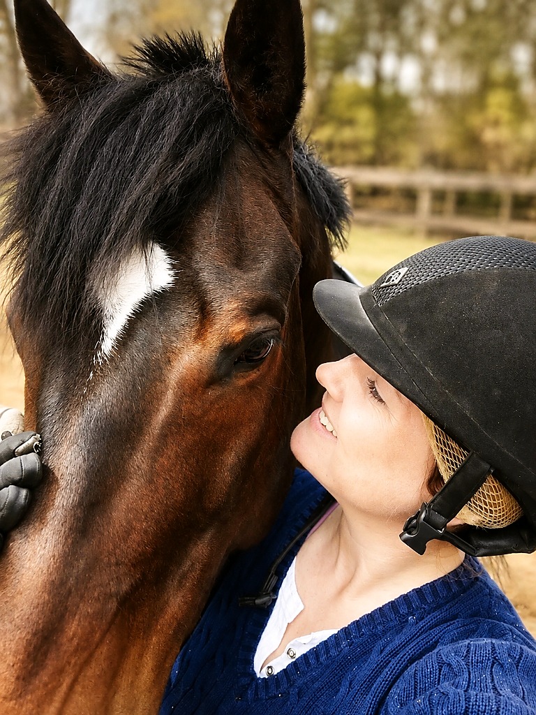 Carolyn Sabolis-Hall sharing an affectionate, gentle moment with her performance horse.